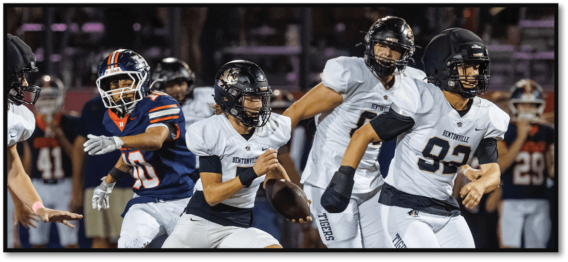 A group of football players on a field. Description generated by AI