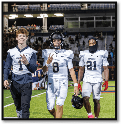 A group of men wearing black and white jerseys. Description generated by AI