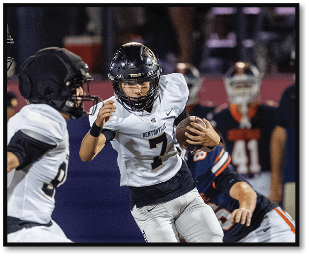 A football player is kicking a football on a field. Description generated by AI