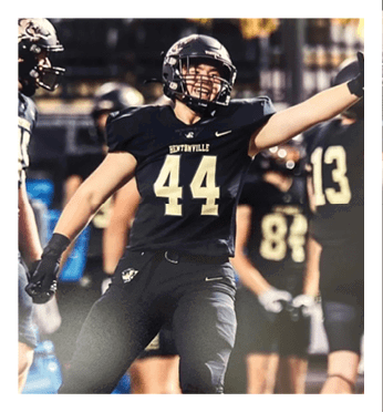 A football player wearing a black jersey with the number 44 on it. Description generated by AI