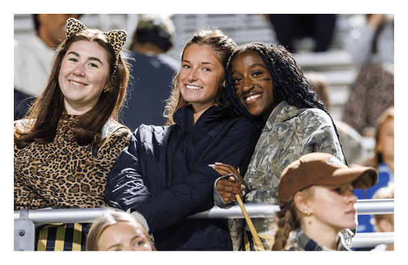 A group of football players wearing headphones and smiling. AI generated content