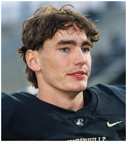 A football player wearing a black helmet and white jersey. Description generated by AI