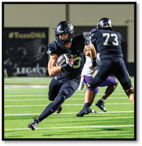 Two football players wearing black jerseys with the number 11 on them. Description generated by AI