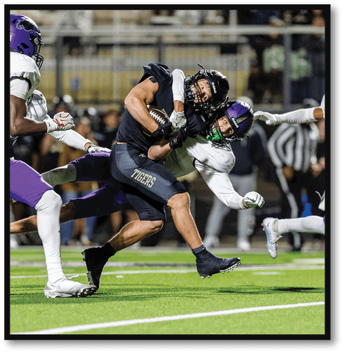 Two football players wearing black jerseys with the number 11 on them. Description generated by AI