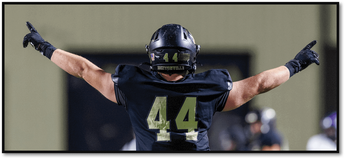 A group of football players on a field. Description generated by AI