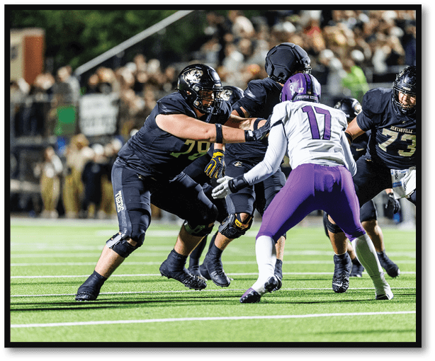 A football player is kicking a football on a field. Description generated by AI
