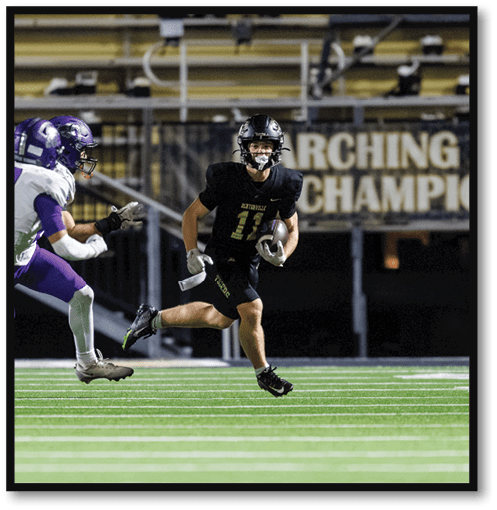 Two football players wearing black jerseys with the number 11 on them. Description generated by AI