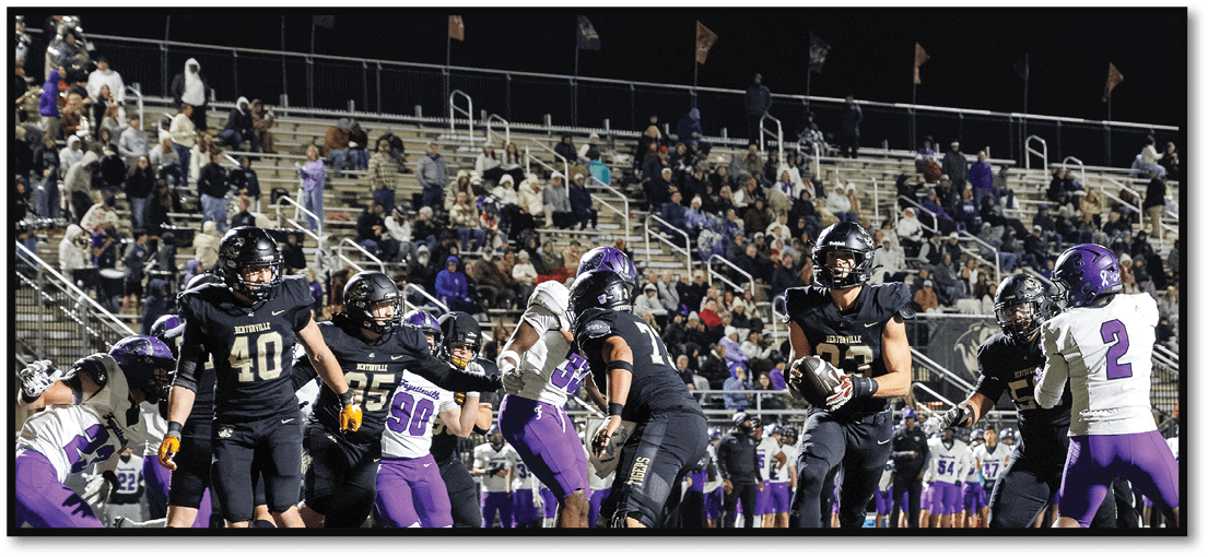 A group of football players on a field. Description generated by AI