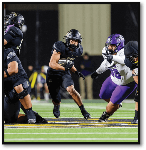 A group of men wearing black and white jerseys. Description generated by AI