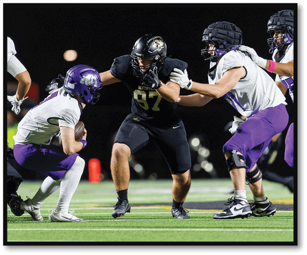 A football player is kicking a football on a field. Description generated by AI