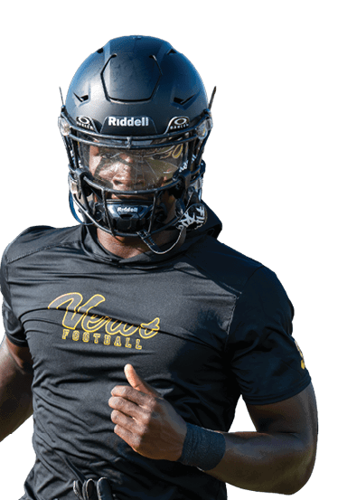 A person wearing a black football helmet and black shirt with yellow pants is running on a field. Descripci n generada con IA