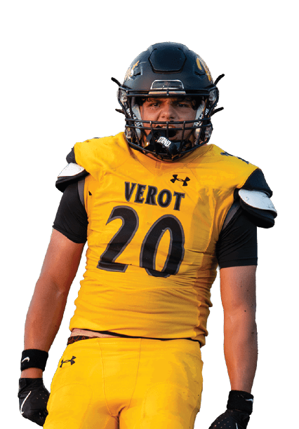 A person in a yellow football uniform with the number 20 stands on a field while other players in white uniforms are visible in the background. Descripci n generada con IA