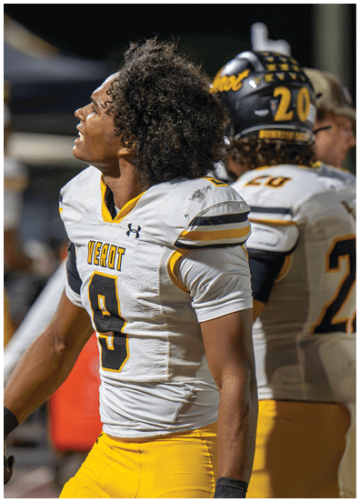 A person wearing a white and yellow football jersey with the word “VEROT" and the number 9 is looking upward with a focused expression. Descripci n generada con IA