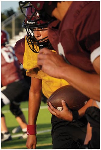 A football game is being played on a field. Description generated by AI