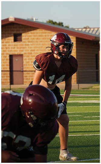 A football player catching a ball. Description generated by AI
