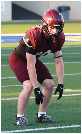 A football player catching a ball. Description generated by AI