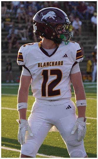 A football player catching a ball. Description generated by AI