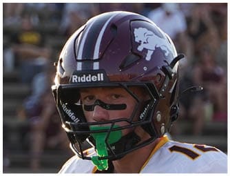 A group of football players on a field. Description generated by AI