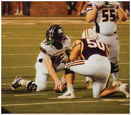 A football player running on the field. Description generated by AI