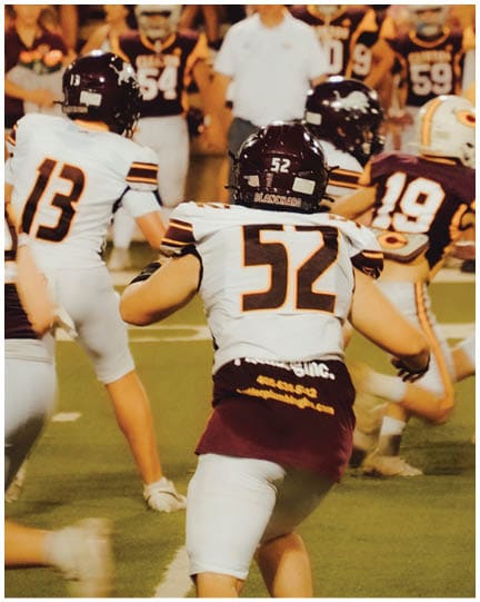 A football player wearing a blue jersey with the number 58 on it. Description generated by AI