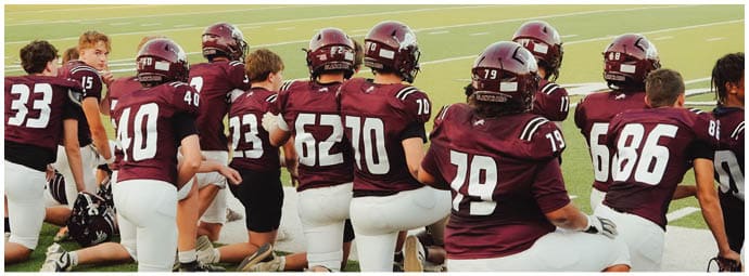 A football player wearing a blue and white uniform. Description generated by AI