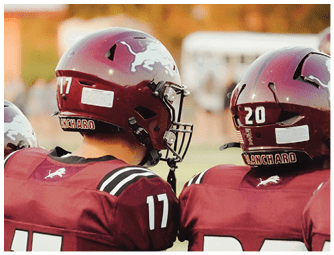A group of football players on a field. Description generated by AI