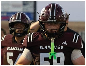 A group of football players on a field. Description generated by AI