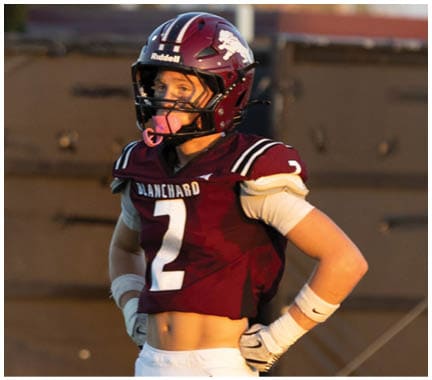 A football player running on the field. Description generated by AI
