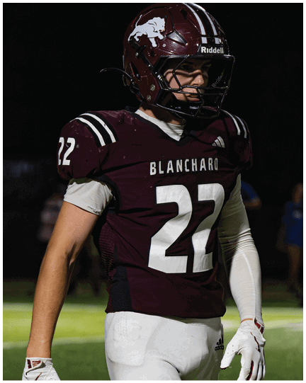 A football player wearing a blue jersey with the number 58 on it. Description generated by AI