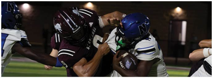 A football player wearing a blue and white uniform. Description generated by AI
