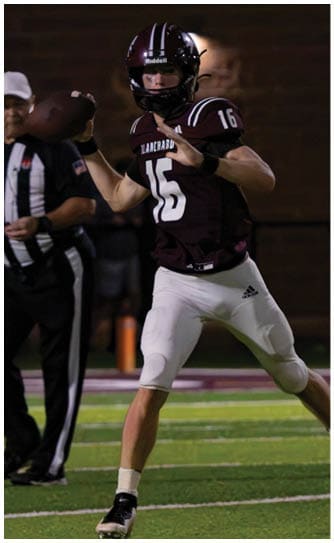 A football player catching a ball. Description generated by AI