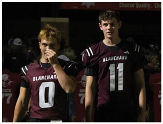 A group of football players on a field. Description generated by AI