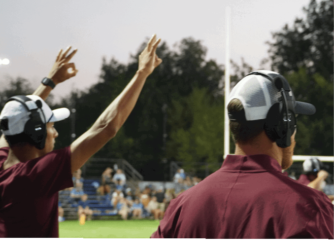 A group of football players in black and white uniforms are on the field. AI generated content
