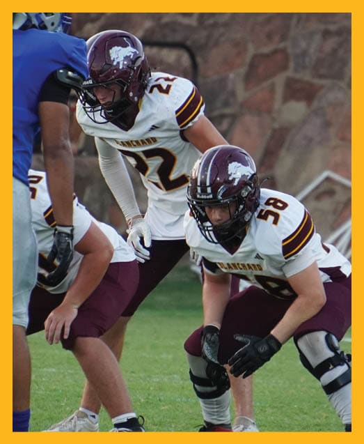 A football player in a white uniform is running with a football in his hand. AI generated content