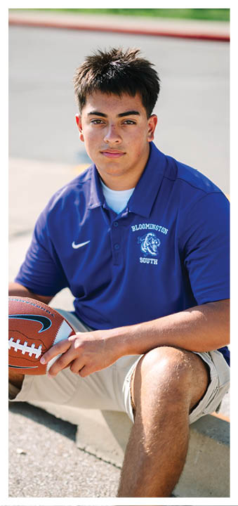 A football player wearing a blue and red jersey. Description generated by AI