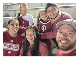 Two football players wearing black jerseys with the word Vista on them. Description generated by AI