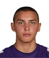 A person wearing a purple Bloomington sports jersey with the number 34 stands facing forward against a white background. Description generated by AI