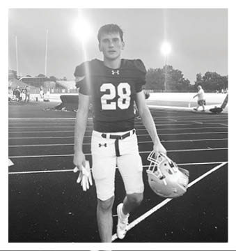 A football player wearing a blue and red jersey. Description generated by AI
