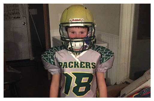 A football player wearing a blue and red jersey. Description generated by AI