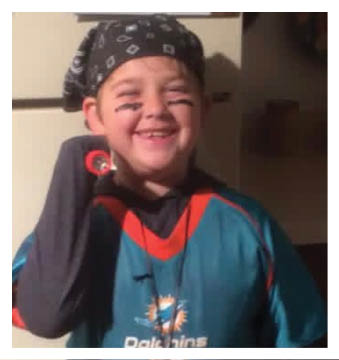 A football player wearing a blue and red jersey. Description generated by AI