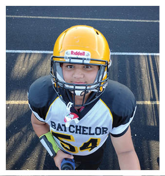 A football player wearing a blue and red jersey. Description generated by AI