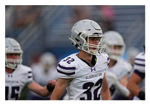 Two football players wearing black jerseys with the word Vista on them. Description generated by AI