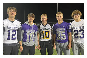 Two football players wearing black jerseys with the word Vista on them. Description generated by AI