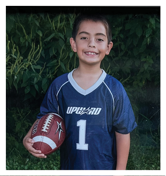A football player wearing a blue and red jersey. Description generated by AI