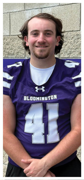 A football player wearing a blue and red jersey. Description generated by AI