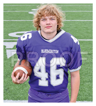 A football player wearing a blue and red jersey. Description generated by AI