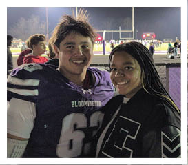 Two football players wearing black jerseys with the word Vista on them. Description generated by AI