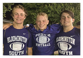 Two football players wearing black jerseys with the word Vista on them. Description generated by AI