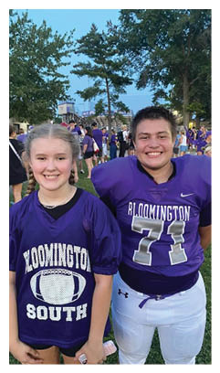 Two football players wearing black jerseys with the word Vista on them. Description generated by AI