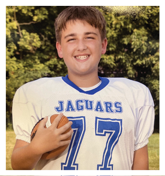 A football player wearing a blue and red jersey. Description generated by AI